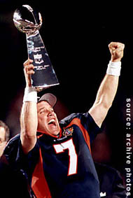 John Elway holding aloft the Vince Lombardi Trophy