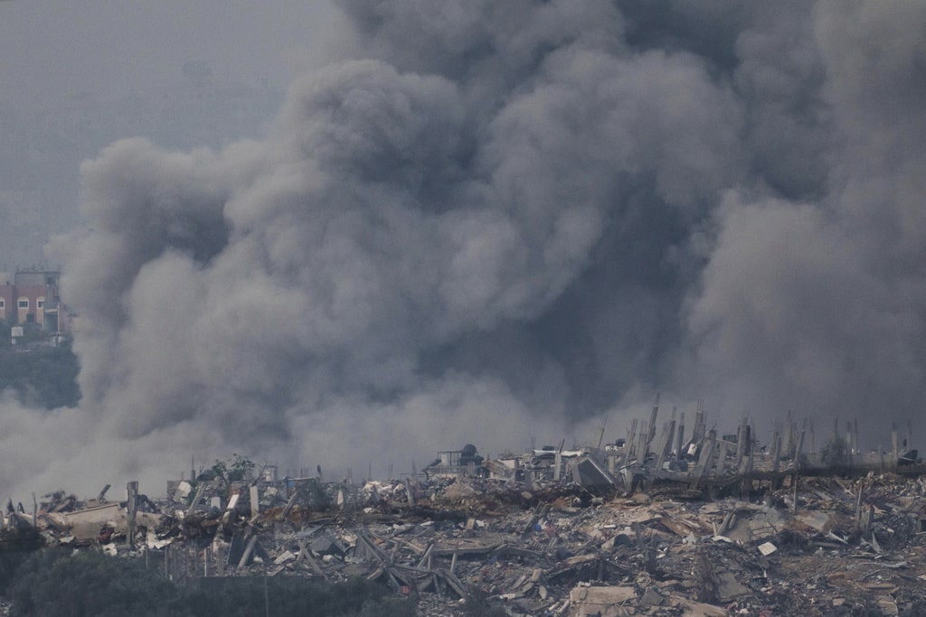 Smoke rises following an Israeli bombardment in the Gaza Strip, as seen from southern Israel, Thursday, Dec. 7, 2023.