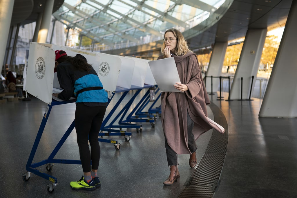 voter moves to cast her ballot at an electronic counting machine at a polling site at the Brooklyn Museum, Nov. 8, 2022, in the Brooklyn borough of New York. New York's highest court has ordered the state to draw new congressional districts ahead of the 2024 elections. The decision from the New York Court of Appeals on Tuesday, Dec. 12, 2023, could give Democrats a advantage in what is expected to be a battleground for control of the U.S. House.
