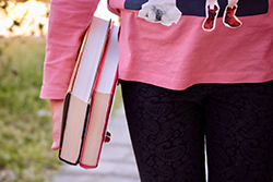A person holding books of poetry